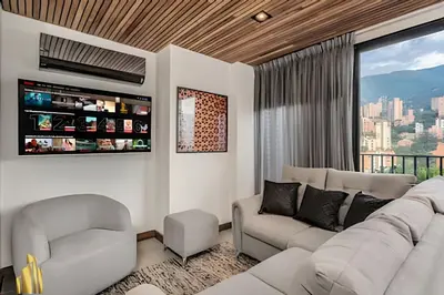 a living room with a couch and a tv at Morph 1802 - Stylish Escape in Poblado AC/Jacuzzi in El Poblado