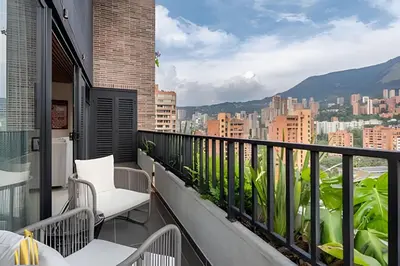a balcony with chairs and a view of a city at Morph 1802 - Stylish Escape in Poblado AC/Jacuzzi in El Poblado