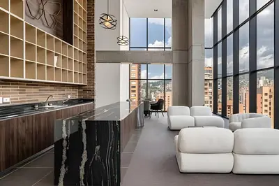 a lobby with white chairs and a counter and windows at Morph 1901 - Cozy Space with priv Balcony/BBQ in El Poblado
