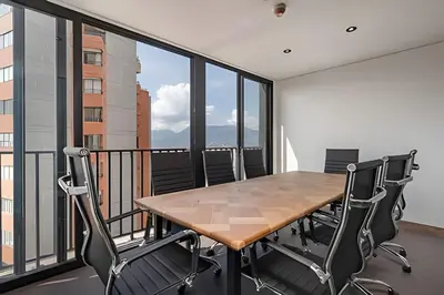 a conference room with a table and chairs on a balcony at Morph 1901 - Cozy Space with priv Balcony/BBQ in El Poblado