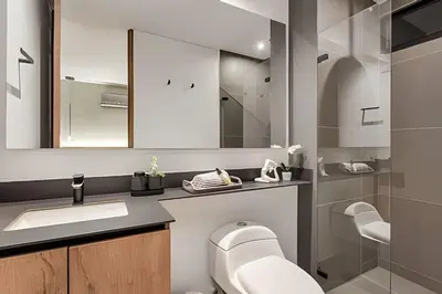 a bathroom with a toilet and a sink and a mirror at Morph 1901 - Cozy Space with priv Balcony/BBQ in El Poblado