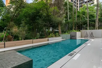 a swimming pool with blue water in a building at Morph 1901 - Cozy Space with priv Balcony/BBQ in El Poblado