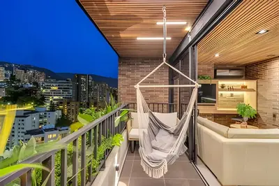 a hammock hanging on the balcony of a building at Morph 1901 - Cozy Space with priv Balcony/BBQ in El Poblado