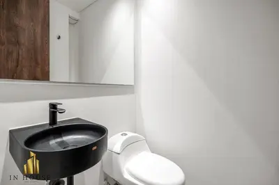a bathroom with a toilet and a sink at Morph 201 - High ceilings & modern apt/BBQ in El Poblado