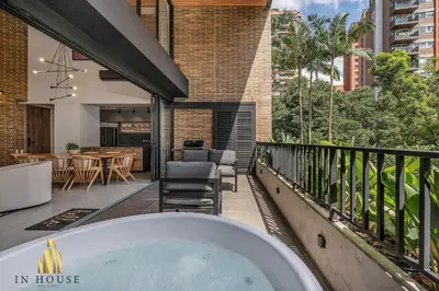 a bath tub on the balcony of a house at Morph 201 - High ceilings & modern apt/BBQ in El Poblado