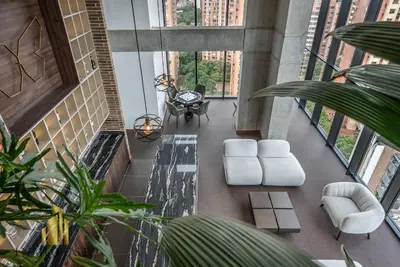 a living room with white furniture and large windows at Morph 201 - High ceilings & modern apt/BBQ in El Poblado