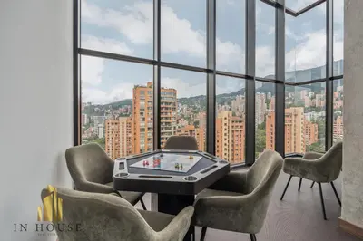 a room with a table and chairs and a large window at Morph 201 - High ceilings & modern apt/BBQ in El Poblado