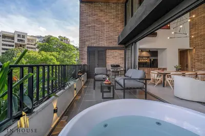 a bath tub on the balcony of a house at Morph 302 - Modern apt high ceilings BBQ/Jacuzzi in El Poblado