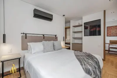 a bedroom with a large white bed in a room at Morph 401 - Modern apt High Ceilings BBQ/Jacuzzi in El Poblado