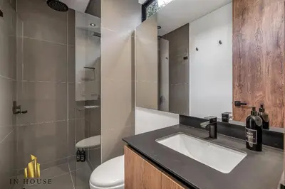 a bathroom with a sink and a toilet at Morph 401 - Modern apt High Ceilings BBQ/Jacuzzi in El Poblado
