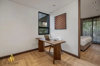 a room with a desk with a laptop on it at Morph 401 - Modern apt High Ceilings BBQ/Jacuzzi in El Poblado