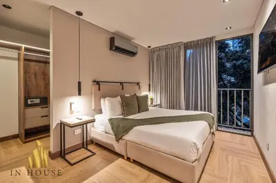 a bedroom with a bed and a large window at Morph 402 - Serene Getaway: Jacuzzi, AC, BBQ in El Poblado