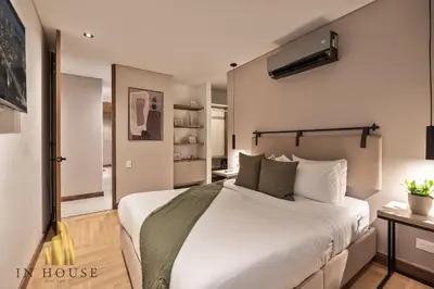 a bedroom with a large white bed in a room at Morph 402 - Serene Getaway: Jacuzzi, AC, BBQ in El Poblado