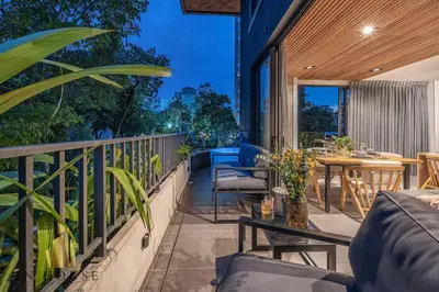 an outdoor patio with a table and chairs on a balcony at Morph 402 - Serene Getaway: Jacuzzi, AC, BBQ in El Poblado
