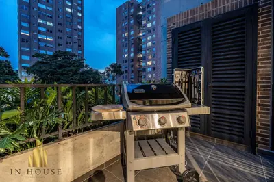 a bbq grill on a balcony in a city at Morph 402 - Serene Getaway: Jacuzzi, AC, BBQ in El Poblado