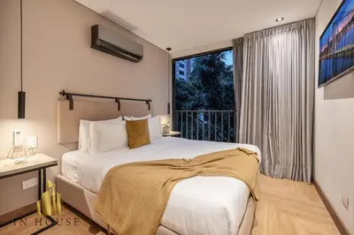 a bedroom with a bed and a large window at Morph 402 - Serene Getaway: Jacuzzi, AC, BBQ in El Poblado