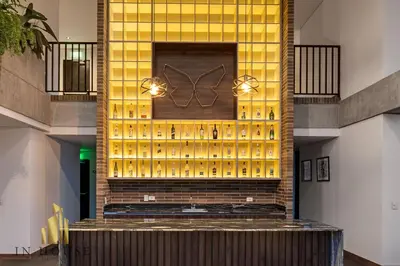 a lobby with a wall of wine bottles at Morph 402 - Serene Getaway: Jacuzzi, AC, BBQ in El Poblado