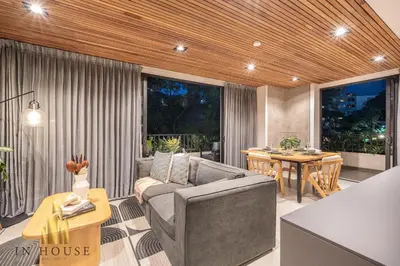 a living room with a couch and a table at Morph 402 - Serene Getaway: Jacuzzi, AC, BBQ in El Poblado