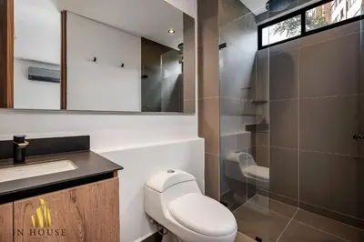 a bathroom with a toilet and a sink and a shower at Morph 501 - Spacious Cozy Apt Poblado/BBQ/Jacuzzi in El Poblado