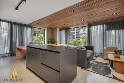 a living room with a kitchen and a living room with windows at Morph 501 - Spacious Cozy Apt Poblado/BBQ/Jacuzzi in El Poblado