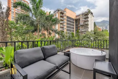a bath tub sitting on a balcony with a chair at Morph 501 - Spacious Cozy Apt Poblado/BBQ/Jacuzzi in El Poblado
