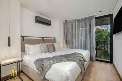 a bedroom with a large bed and a window at Morph 601 - Elegance & tranquility with AC/BBQ in El Poblado