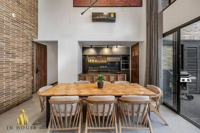 a kitchen and dining room with a wooden table and chairs at Morph 601 - Elegance & tranquility with AC/BBQ in El Poblado