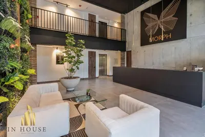 a lobby with two white chairs and a table at Morph 601 - Elegance & tranquility with AC/BBQ in El Poblado