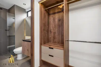 a bathroom with a toilet and a wooden door at Morph 701 - Spacious apt City View Haven in El Poblado