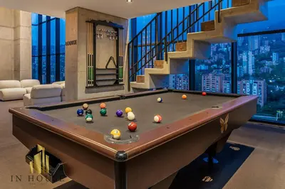 a pool table in a room with a staircase at Morph 701 - Spacious apt City View Haven in El Poblado