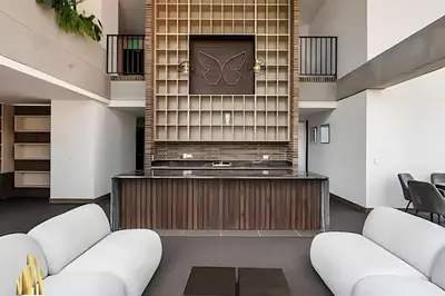a lobby with white leather chairs and a fireplace at Morph 702 - Luxy Apartment with Panoramic View, AC in El Poblado