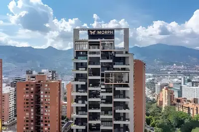 a tall building with a sign on top of it at Morph 702 - Luxy Apartment with Panoramic View, AC in El Poblado