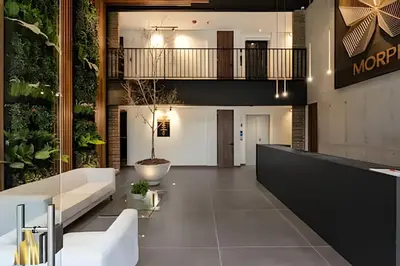 a lobby of a building with a couch and plants at Morph 702 - Luxy Apartment with Panoramic View, AC in El Poblado