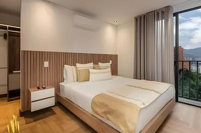 a bedroom with a large bed and a large window at Morph 702 - Luxy Apartment with Panoramic View, AC in El Poblado