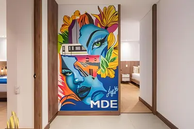 a room with a door with a painting of people at Morph 702 - Luxy Apartment with Panoramic View, AC in El Poblado