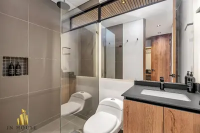 a bathroom with a sink and a toilet and a mirror at Morph 902 - Luxury Apt in Poblado with Balcony in El Poblado