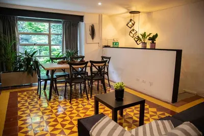 a living room with a table and chairs at Poblado-Manila encantador apartamento in Medellín