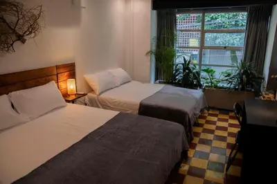 a hotel room with two beds and a window at Poblado-Manila encantador apartamento in Medellín