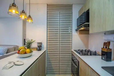 a kitchen with a bowl of fruit on a counter at Beautiful apartment in Poblado in Medellín