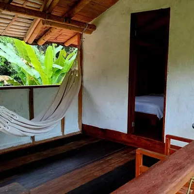 a room with a bed and a hammock in it at Refugio Cumaná in San Rafael