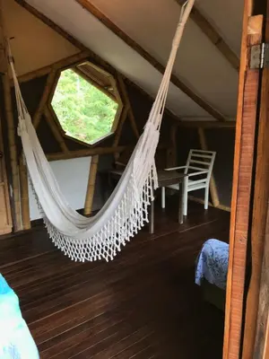 a hammock in a room with a window at Refugio Cumaná in San Rafael