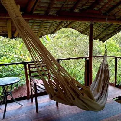 a hammock is hanging from a roof on a porch at Refugio Cumaná in San Rafael