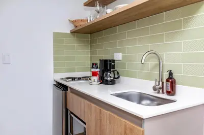 a kitchen with a sink and a counter top at Laureles Apt-Big Windows-Smart lock- AC in Medellín