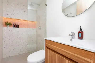 a bathroom with a sink and a mirror at Laureles Apt-Big Windows-Smart lock- AC in Medellín