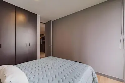 a bedroom with a bed and a wall at Next Avenue 702 - Apt with balcony and AC/Poblado in El Poblado