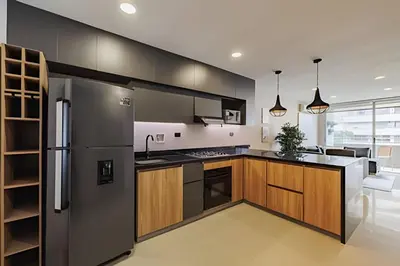 a kitchen with a stainless steel refrigerator and wooden cabinets at Next Avenue 702 - Apt with balcony and AC/Poblado in El Poblado
