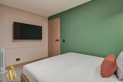 a bedroom with a bed and a flat screen tv at Paola 201 - Charm and perfect location in Laureles in Guayaquil