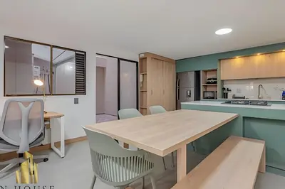 a kitchen with a wooden table and chairs at Paola 201 - Charm and perfect location in Laureles in Guayaquil
