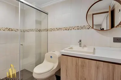 a bathroom with a toilet and a sink and a mirror at Paola 201 - Charm and perfect location in Laureles in Guayaquil