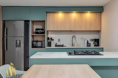 a kitchen with a counter top and a refrigerator at Paola 201 - Charm and perfect location in Laureles in Guayaquil